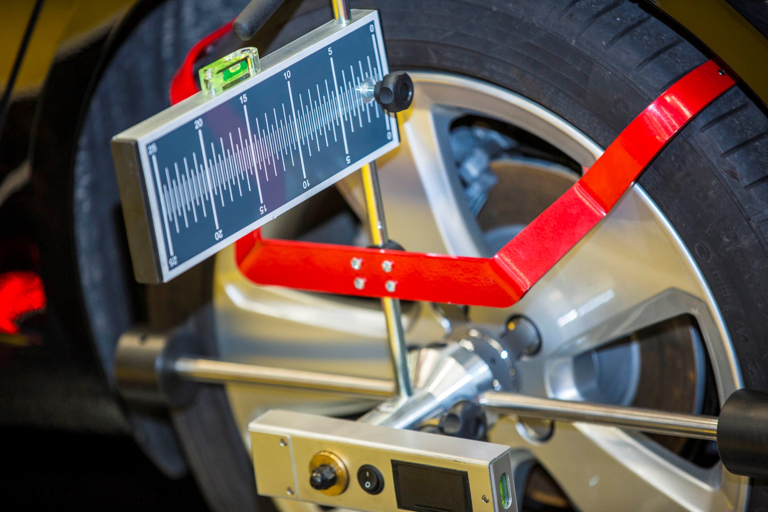 close up of car wheel with calibration instrument set up